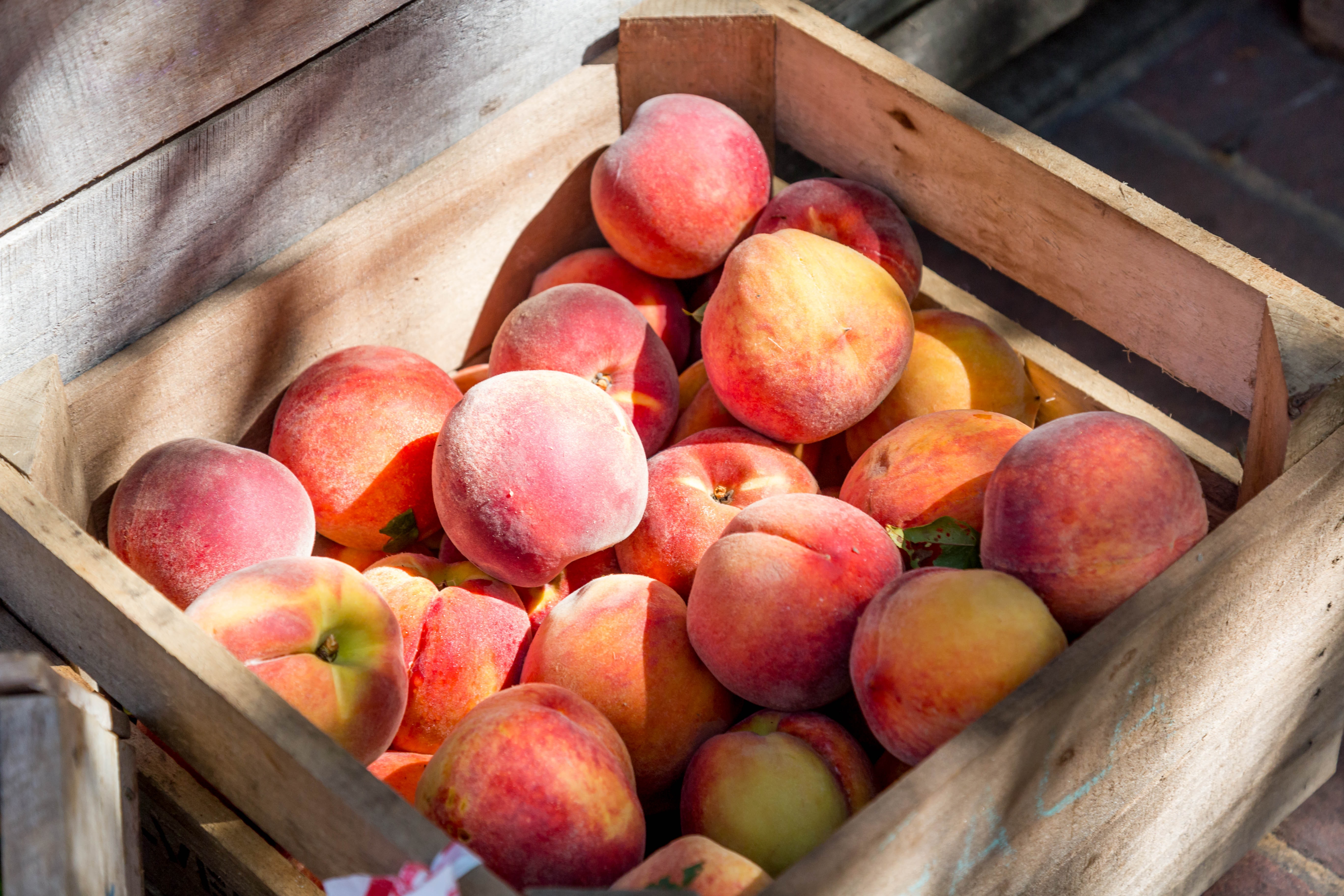 wooden crate full of peaches