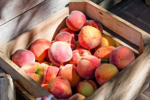 wooden crate full of peaches