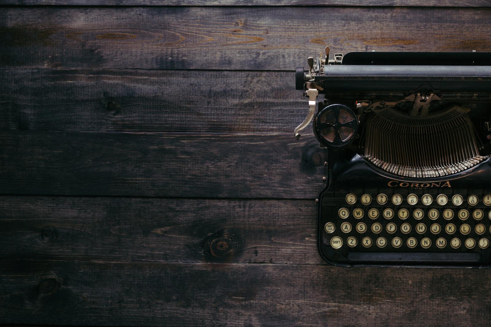 Old typewriter on wooden surface